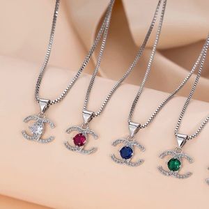 Gold Charm Necklace brand new. Colors Red, Blue, White, and Emerald.